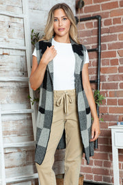 Geometric knit duster vest in black and tan checkered pattern, acrylic, sleeveless, open front.