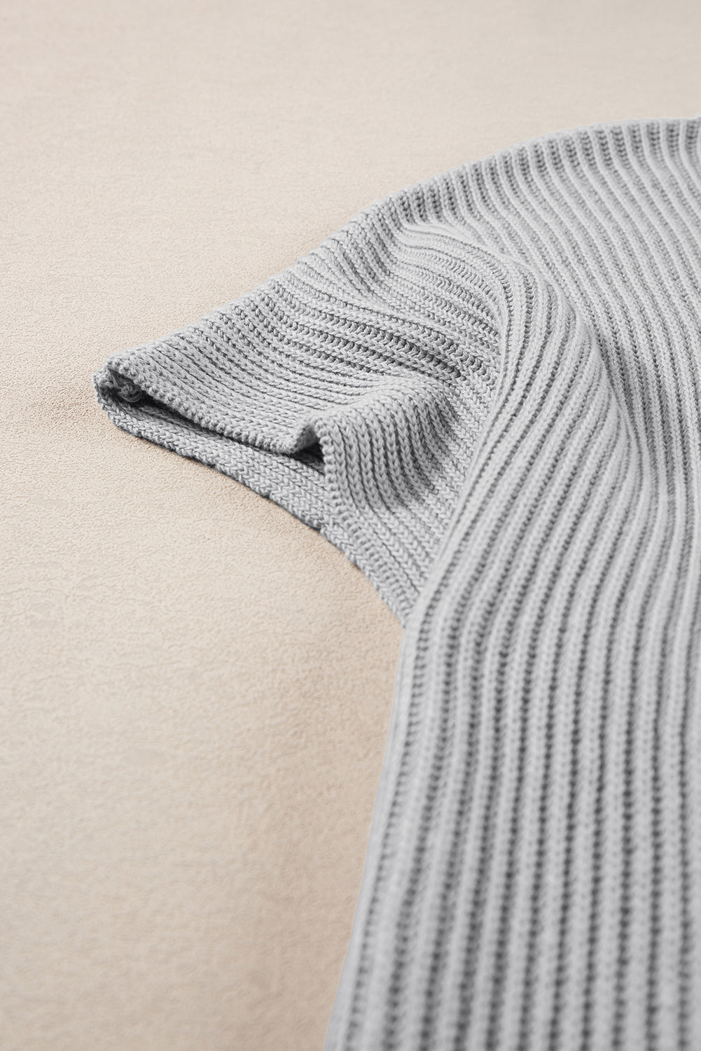 Gray ribbed knit cape sleeve top with a casual chic style.