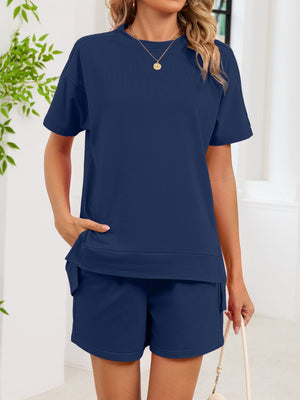 Navy blue relaxed two-piece set with crew neck t-shirt and shorts, both with pockets.