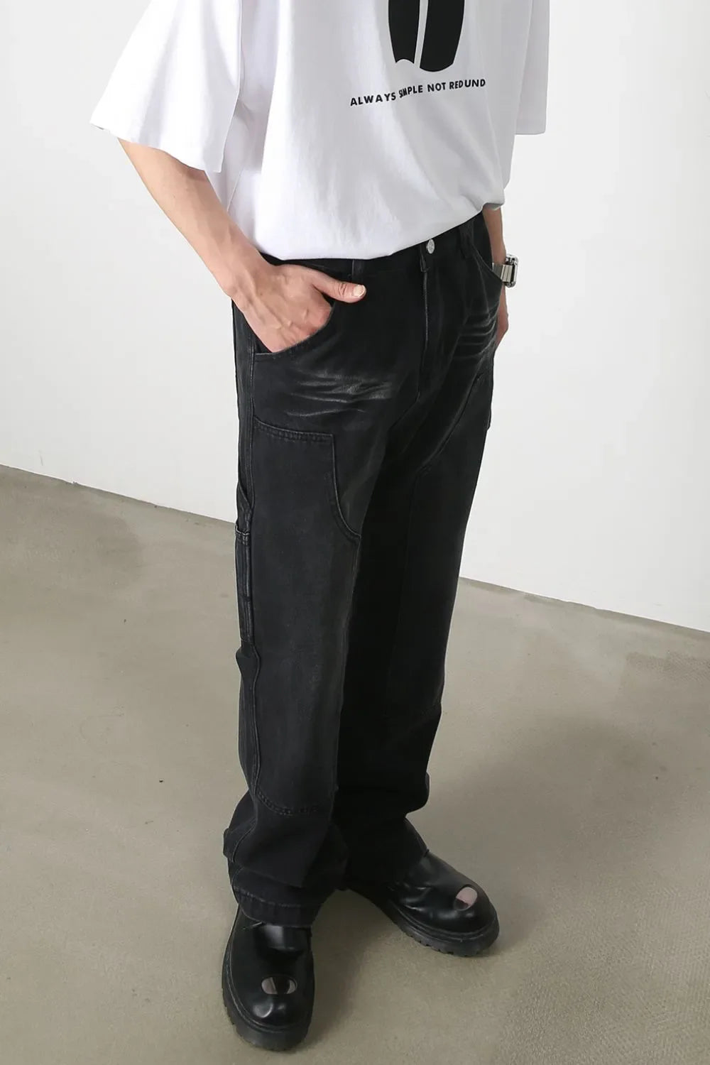 Dark wash denim wide leg carpenter jeans with utility pockets and a relaxed fit.