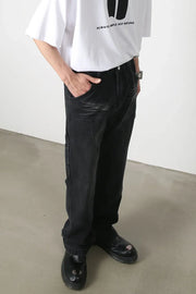 Dark wash denim wide leg carpenter jeans with utility pockets and a relaxed fit.