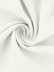 White polyester pajama fabric with soft ruffles and a textured weave.