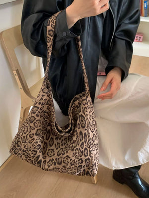 Leopard print tote bag with fabric straps and a slouchy silhouette.