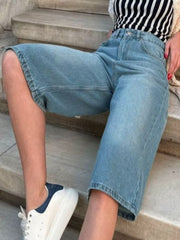 Culotte-cut denim bermuda shorts in Dusty Blue with a relaxed fit and buttoned closure.