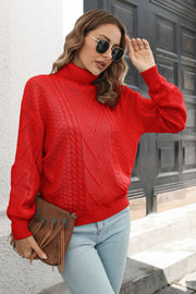 Red acrylic cable knit turtleneck sweater with chevron pattern and ribbed cuffs.