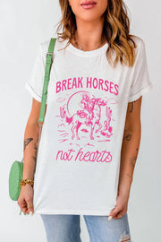 White graphic tee with pink "Break Horses not hearts" desert print and cowboy on horseback.