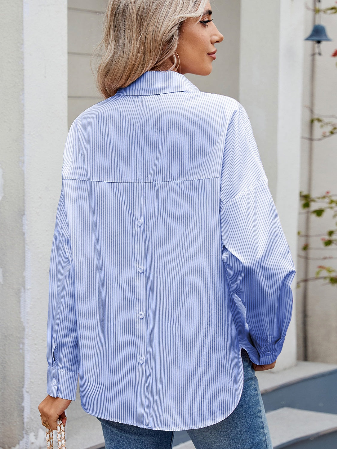 Relaxed fit pinstripe button-down shirt in pastel blue with back button detail.