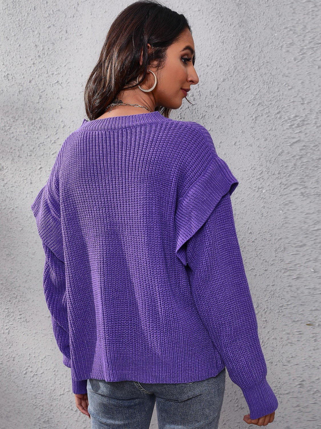 Purple ribbed knit pullover sweater with ruffled sleeves.
