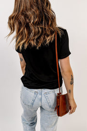 Black crewneck tee with scattered bow embellishments, short sleeves, and a casual fit.