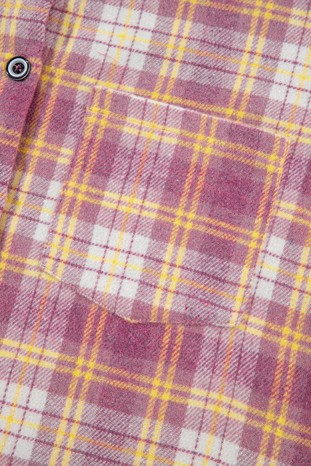 Oversized pink plaid flannel overshirt with a chest pocket and button detail.