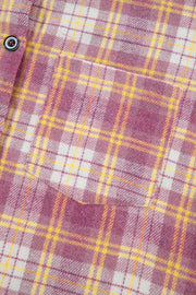 Oversized pink plaid flannel overshirt with a chest pocket and button detail.