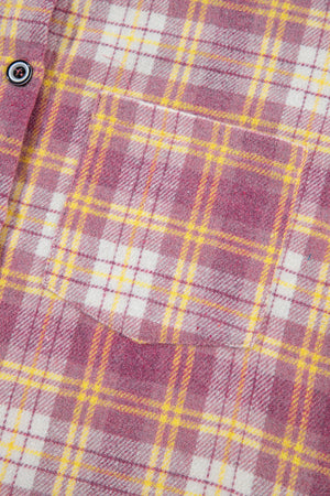 Oversized pink plaid flannel overshirt with a chest pocket and button detail.