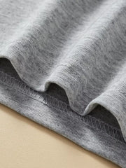 Grey cotton toddler top and shorts set detail showing stitching and fabric texture.