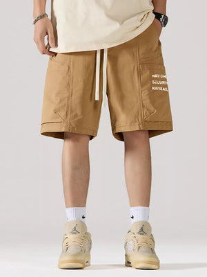 Khaki cotton cargo shorts with adjustable drawstring and side pocket graphic.
