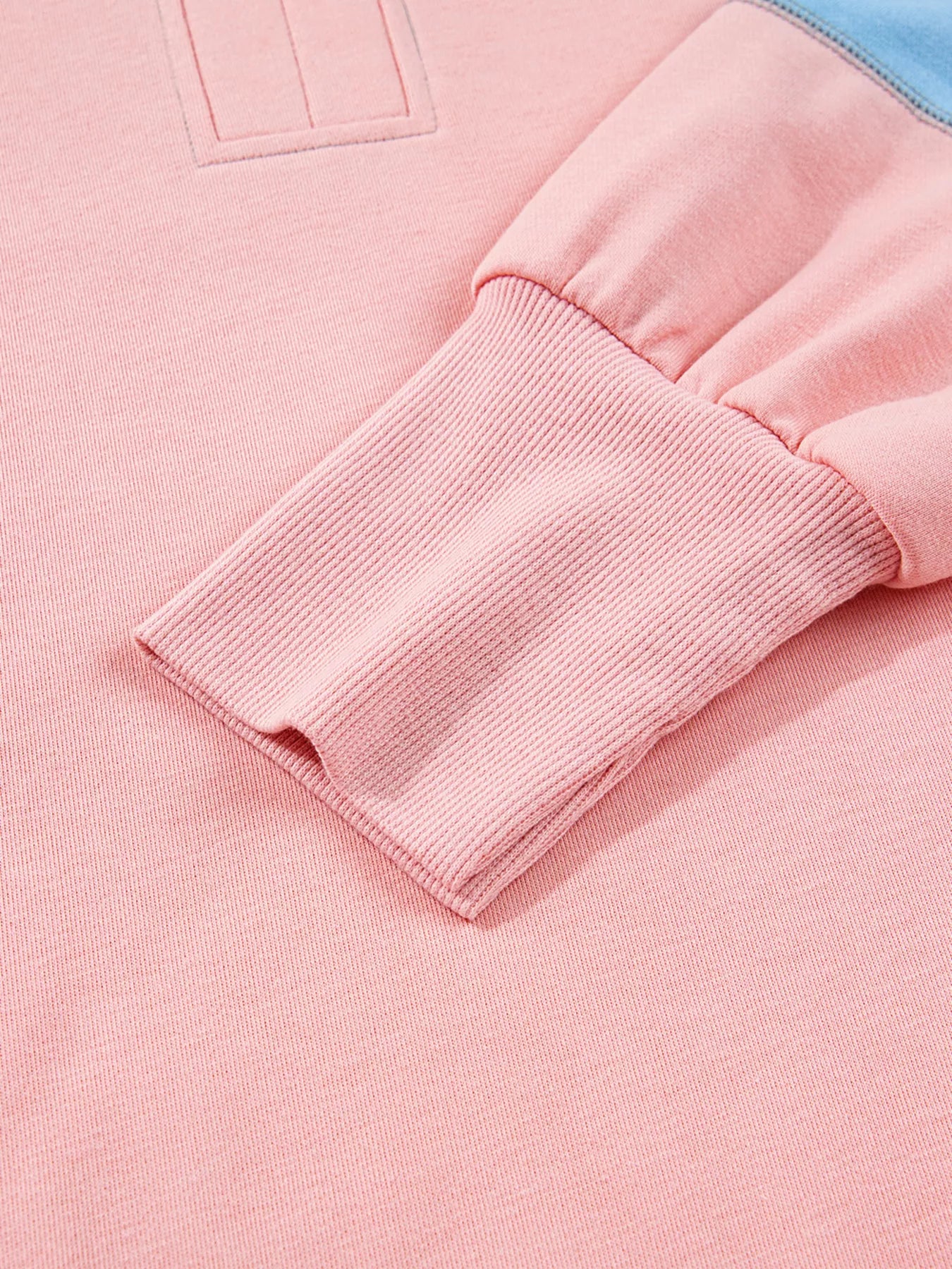 Oversized sweatshirt in dusty pink with contrast stitching detail and ribbed cuffs.