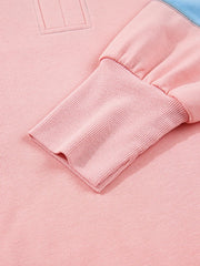 Oversized sweatshirt in dusty pink with contrast stitching detail and ribbed cuffs.