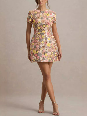 Floral sequin mini dress with short sleeves and a crew neck, featuring a colorful floral pattern.