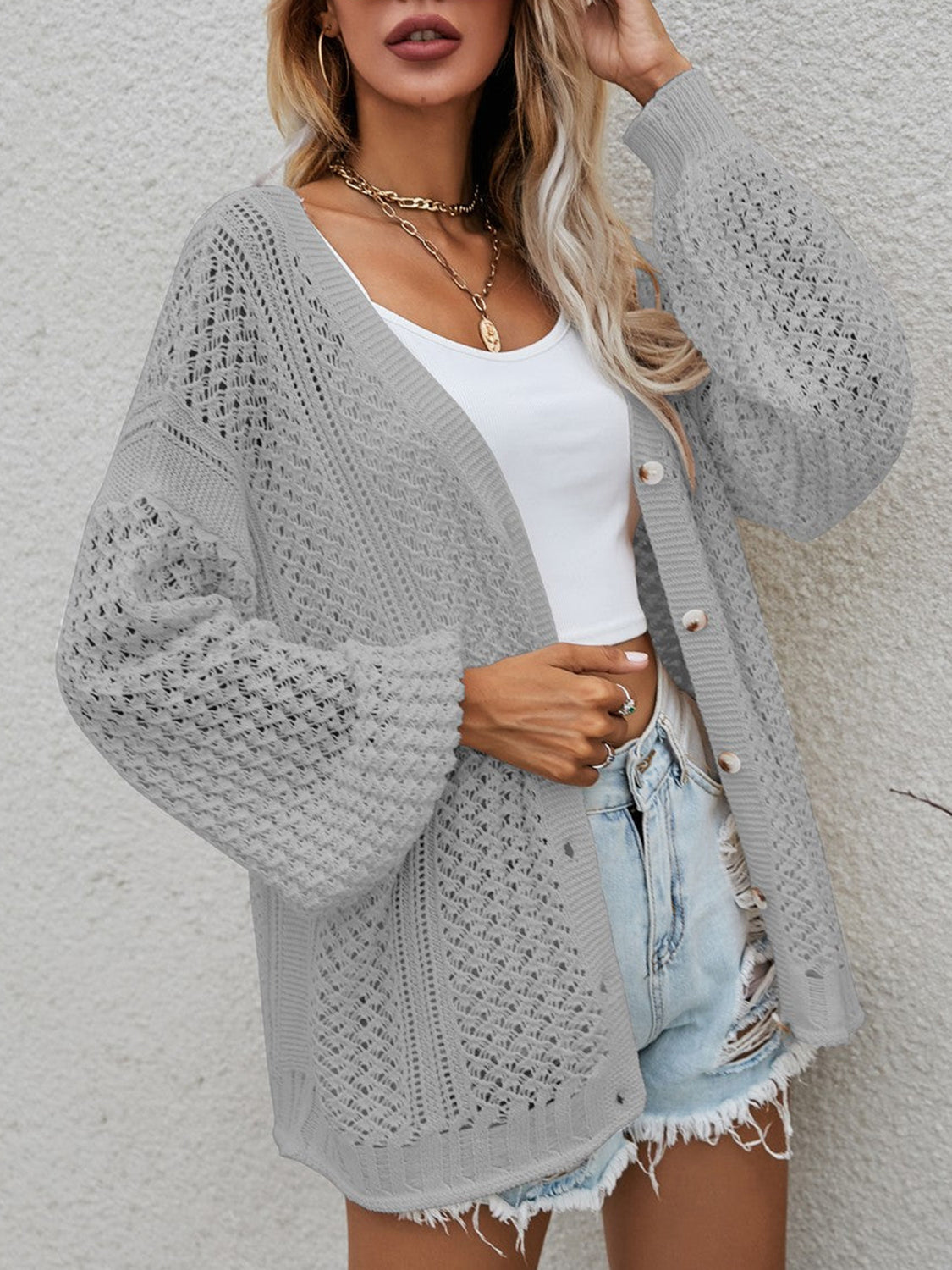 Open-knit button-down cardigan in cloudy blue with balloon sleeves and a relaxed fit.
