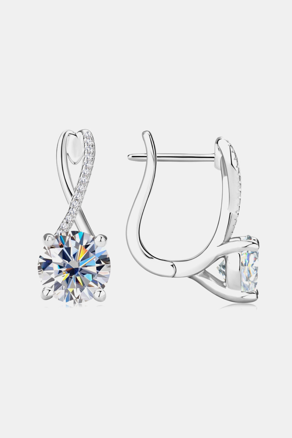 Silver crossover moissanite huggie earrings with sparkling accents.
