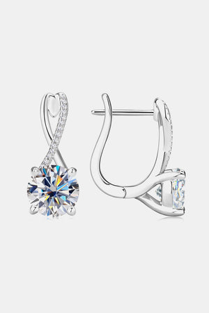Silver crossover moissanite huggie earrings with sparkling accents.