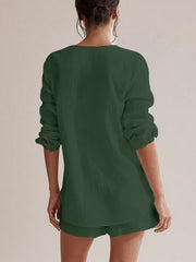 Textured cotton pajama set in dark green with long sleeves and shorts.