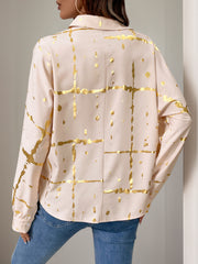 Tan blouse with gold brushstroke pattern and gathered sleeves.