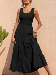 Black smocked bodice ruffled maxi dress with tiered skirt and scoop neck.
