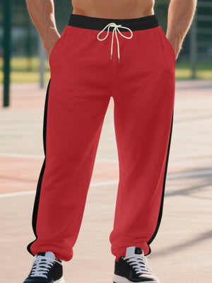 Men's bright red sweatpants with black side stripes and drawstring waist