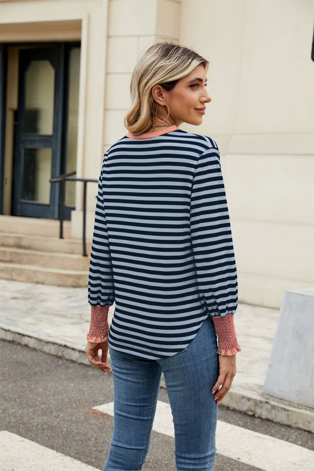 Striped long sleeve blouse with ruched cuffs and neckline, in navy and light blue stripes.