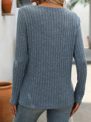 Dusty blue ribbed knit henley top with long sleeves and a keyhole neckline.