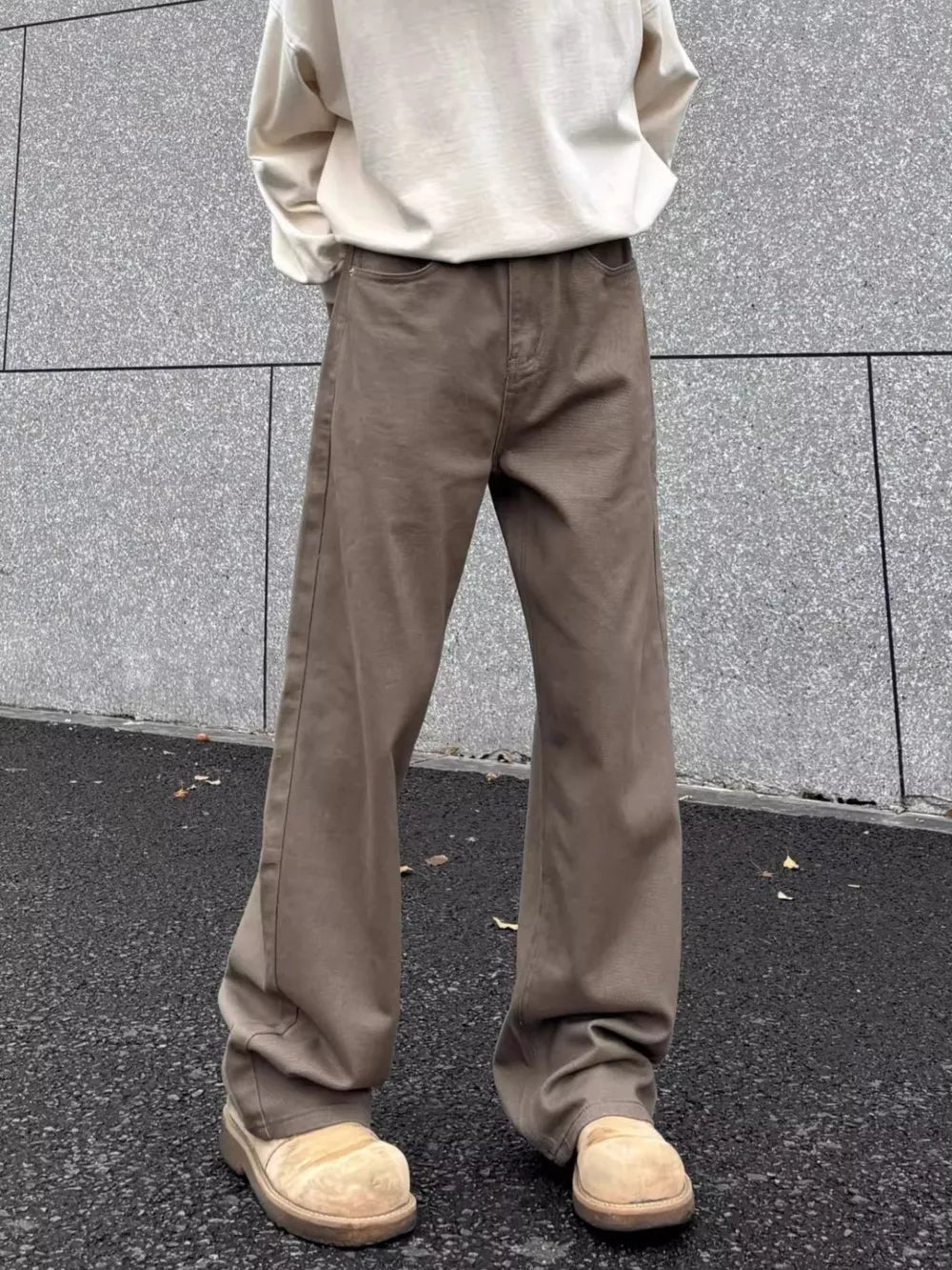 Brown wide-leg sweatpants with pockets, styled with a cream sweatshirt and tan clogs.
