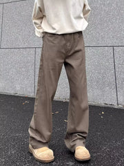 Brown wide-leg sweatpants with pockets, styled with a cream sweatshirt and tan clogs.