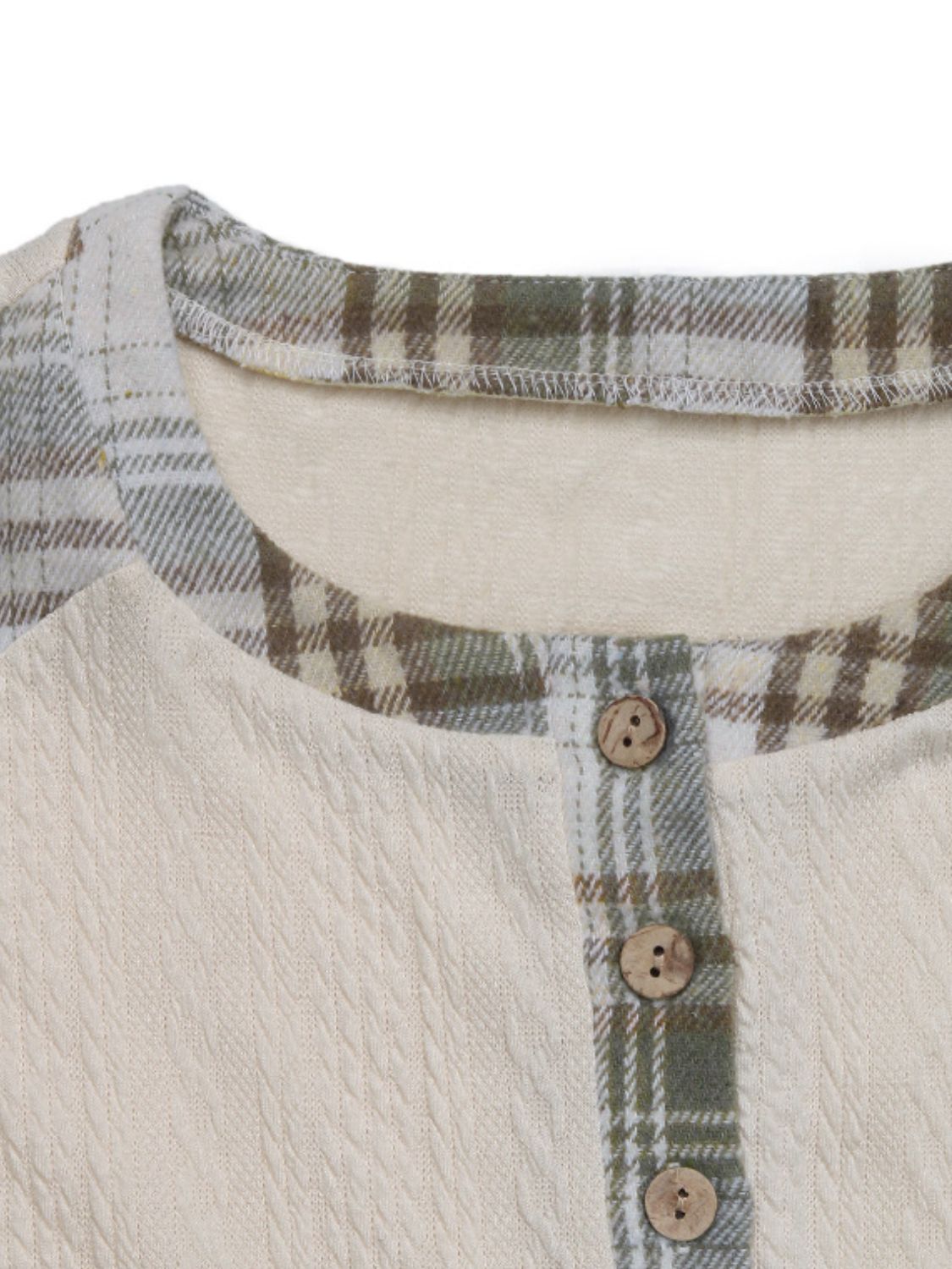 Textured cream raglan henley top with green plaid trim and wood buttons.