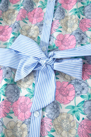 Floral mini dress with contrast stripe trim and belted bow detail.