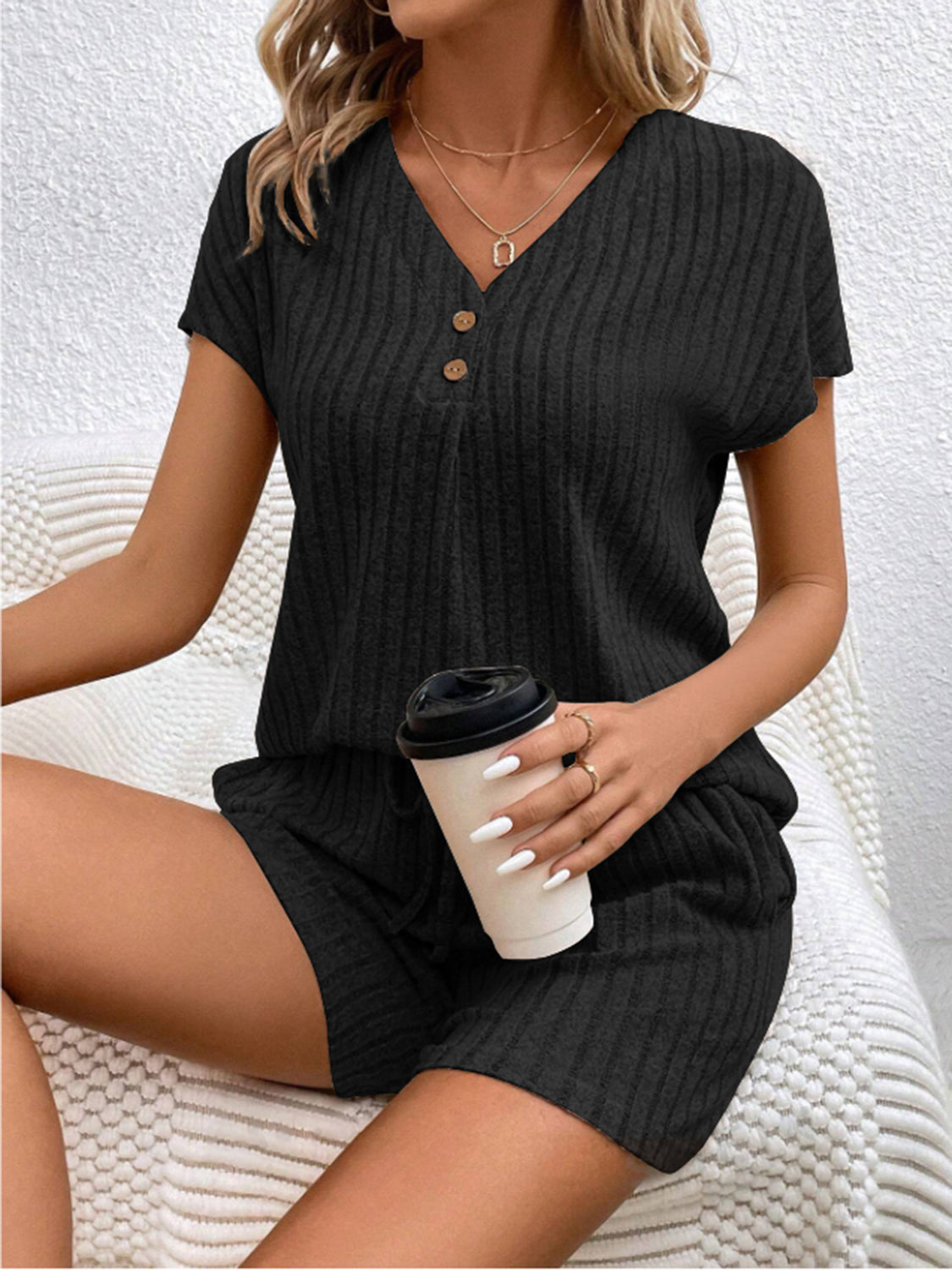Black ribbed knit lounge set with button-down V-neck top and shorts.