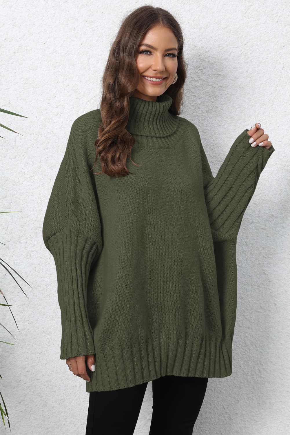 Army green ribbed turtleneck sweater with batwing sleeves and a relaxed fit.