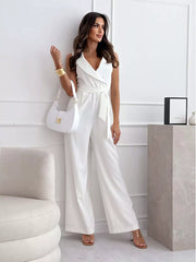 White wrap-front wide-leg romper with V-neck, sleeveless, and belted waist.