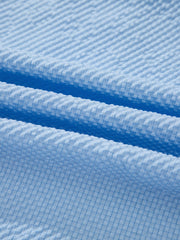 Light blue seersucker fabric detail on a relaxed fit blouse.