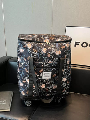 Black floral rolling travel bag with dual zippers and front pocket.