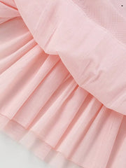 Blush pink toddler dress with tiered skirt detail and subtle polka dots.