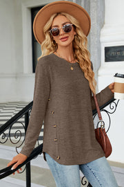 Mocha knit sweater with side button detail and slit hem.