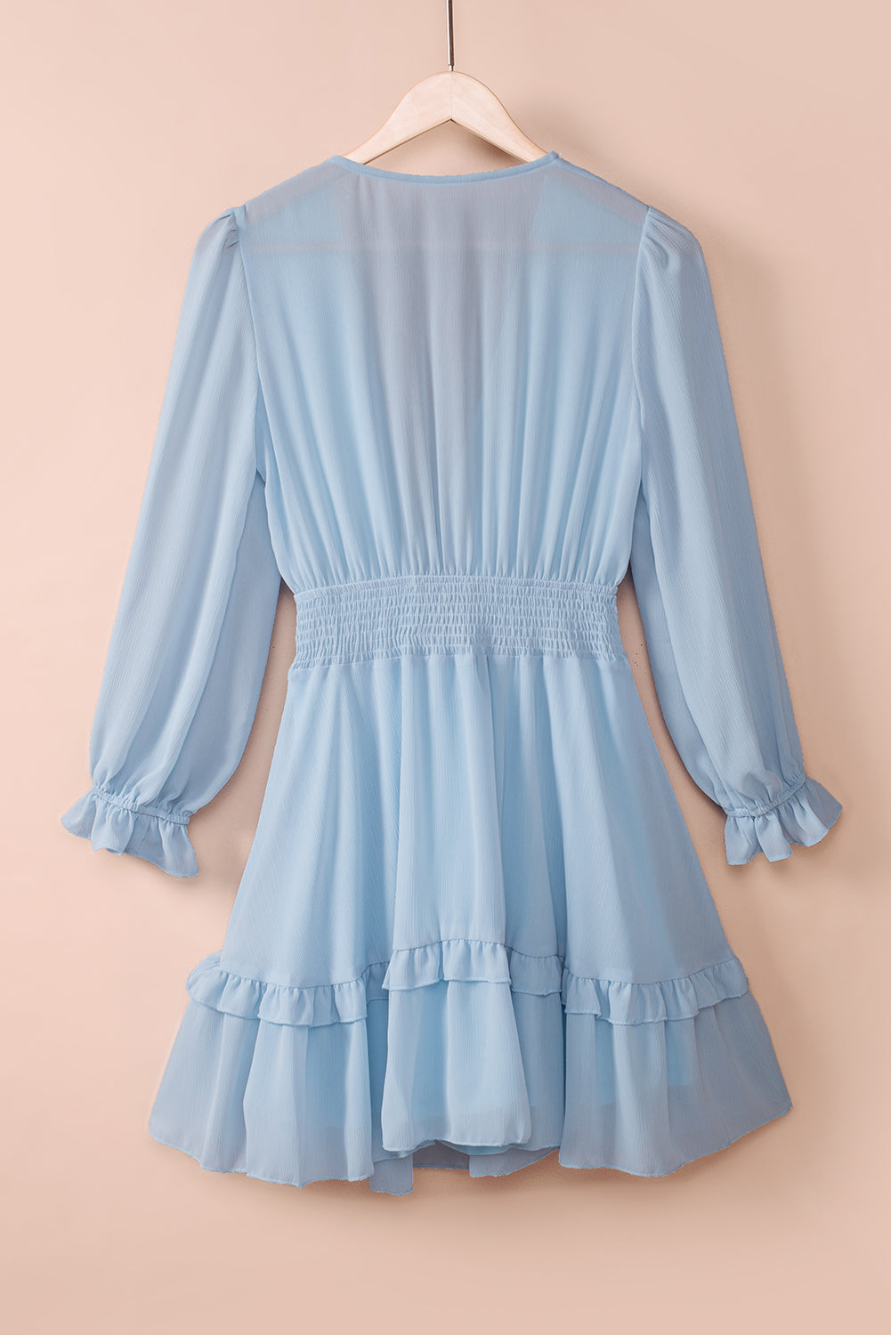Sky blue ruffled mini dress with smocked waist and bell sleeves.