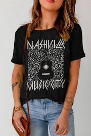 Black graphic tee with Nashville Music City print and guitar graphic on leopard pattern.