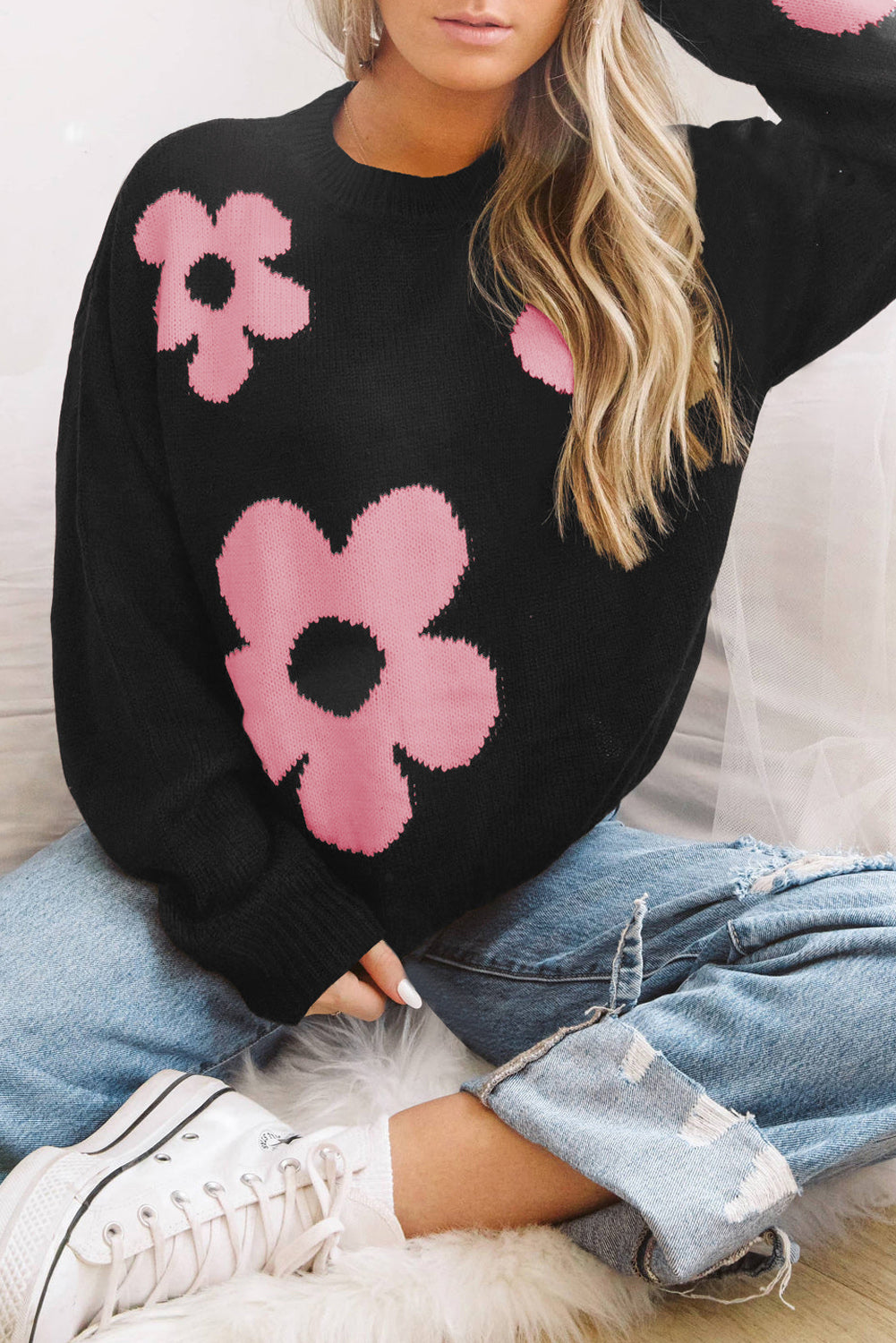 Black acrylic crewneck sweater with pink floral intarsia pattern.