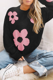 Black acrylic crewneck sweater with pink floral intarsia pattern.
