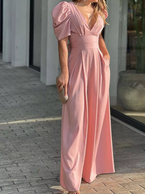 Pink romper with puff sleeves, deep V-neck, cinched waist, and wide legs.