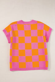Checkerboard knit cap-sleeve top in pink and orange plaid with a crew neck.