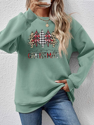 Sage green crewneck sweatshirt with Christmas trees graphic and buffalo plaid accents.
