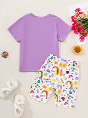 Girls' purple graphic tee and rainbow print shorts set.