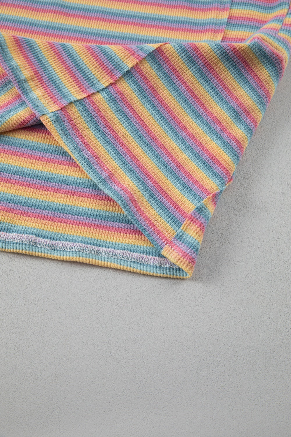 Rainbow stripe loungewear set detail, soft cotton fabric, relaxed fit.